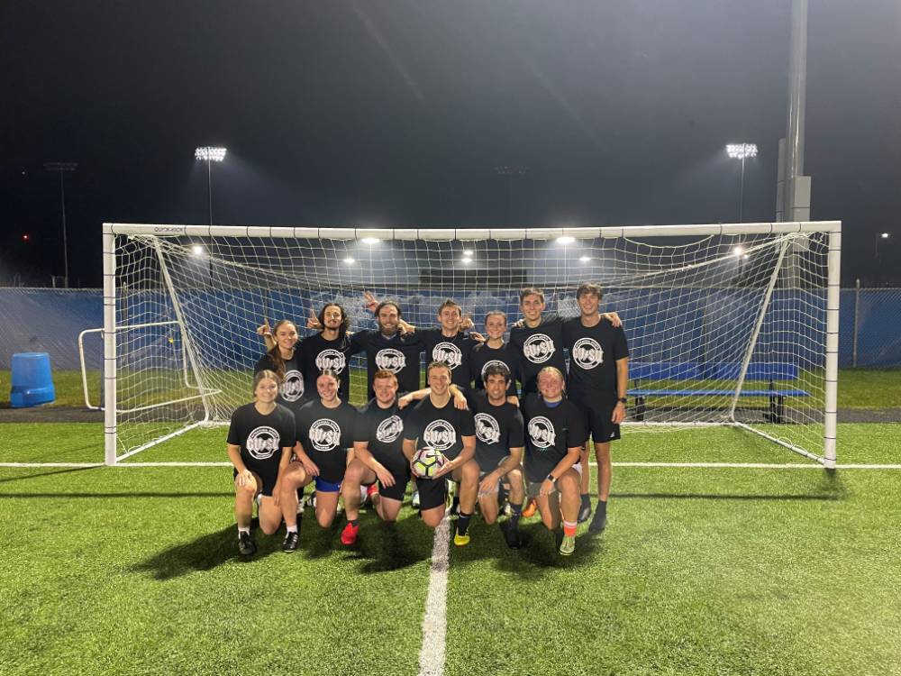 Students wearing championship shirts from a coed soccer tournament
